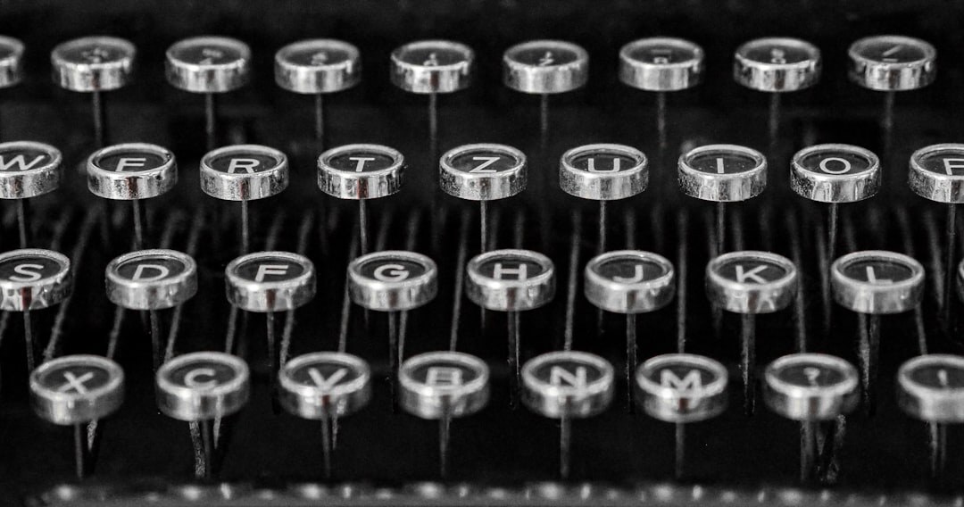 Close-up of vintage typewriter keys with a sheet of paper